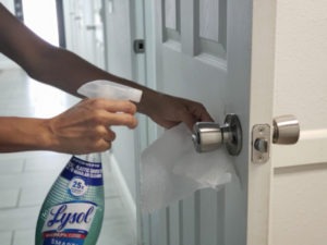 lady cleaning door